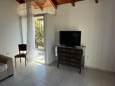 a living room with a flat screen tv on a dresser at Hermoso departamento en alquiler in Cordoba