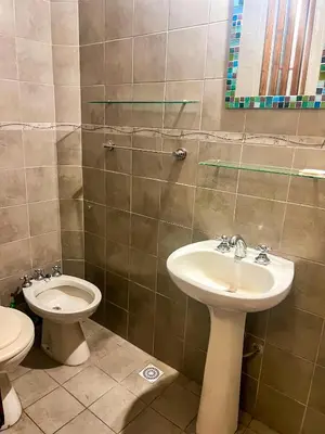 a bathroom with a sink and a toilet at Depto 150 in Villa Carlos Paz