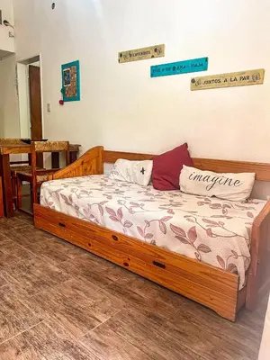 a bedroom with a wooden bed in a room at Depto 150 in Villa Carlos Paz