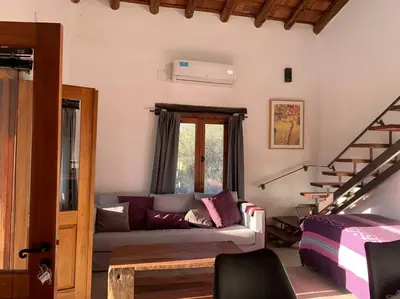 a living room with a couch and a staircase at Casa en La Comarca in San Javier