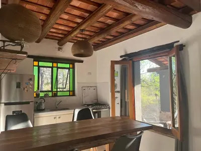 a kitchen with a wooden table and some windows at Casa en La Comarca in San Javier