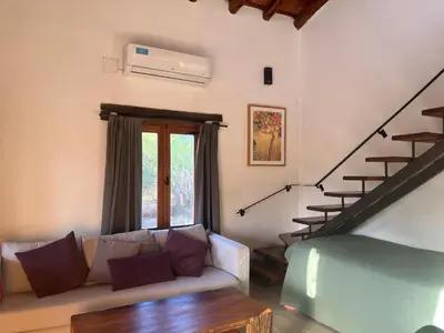 a living room with a couch and a staircase at Casa en La Comarca in San Javier