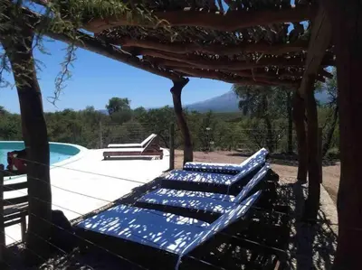 a group of benches sitting next to a pool at Casa en La Comarca in San Javier