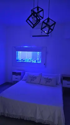 a bedroom with a bed with a blue light at Dpto 1 RaGi in Cordoba