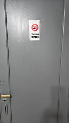 a sign on the side of a metal door at Dpto 1 RaGi in Cordoba