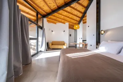 a bedroom with a bed and a couch in a room at Bonaire Aparthotel in Villa General Belgrano