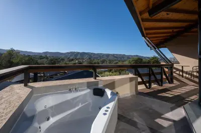 a bath tub on the balcony of a house at Bonaire Aparthotel in Villa General Belgrano