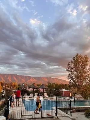 a group of people standing around a swimming pool at MIRADOR DE ESTRELLAS RESORT in Nono