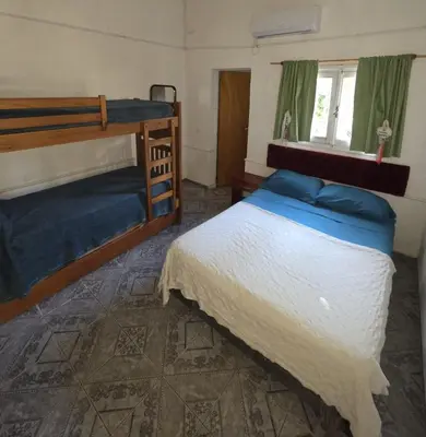 a bedroom with two bunk beds and a window at LUSANYUN 1 in Villa Independencia