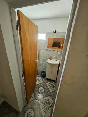a small bathroom with a sink and a door at LUSANYUN 1 in Villa Independencia