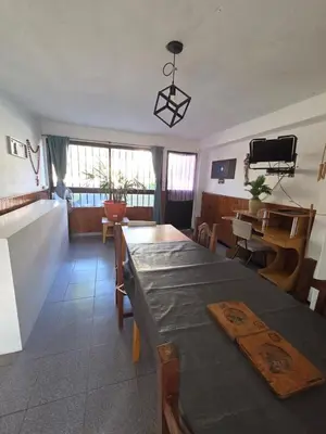 a living room with a table and a dining room at LUSANYUN 1 in Villa Independencia