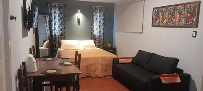 a bedroom with a bed and a table and a couch at Cerro de las Rosas in Cordoba