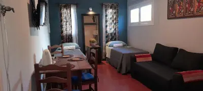 a living room with a couch and a bed and a table at Cerro de las Rosas in Cordoba