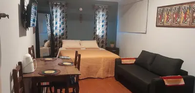 a room with a bed and a table and a couch at Cerro de las Rosas in Cordoba