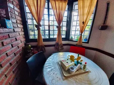a table with a cake on it in a room with windows at Impecable departamento temporario en Córdoba in Cordoba