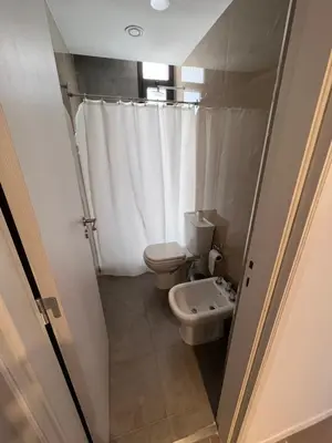 a small bathroom with a toilet and a sink at Departamento en el centro - Lake Tower in Villa Carlos Paz