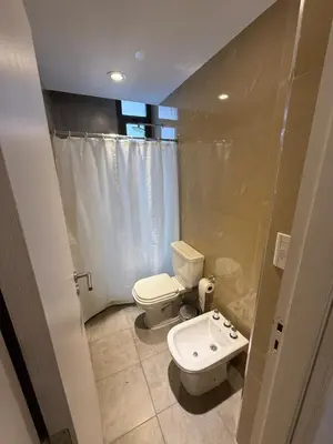 a small bathroom with a toilet and a sink at Departamento en el centro - Lake Tower in Villa Carlos Paz