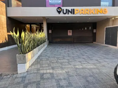 a front door of a building with a parking garage at Departamento en el centro - Lake Tower in Villa Carlos Paz