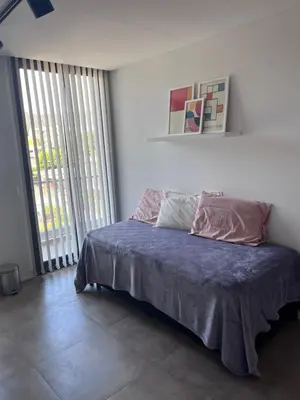 a bedroom with a bed with a blue comforter at Departamento en el centro - Lake Tower in Villa Carlos Paz