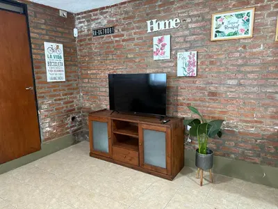 a flat screen tv on a brick wall at Buena Vista Icho Cruz in Villa Icho Cruz
