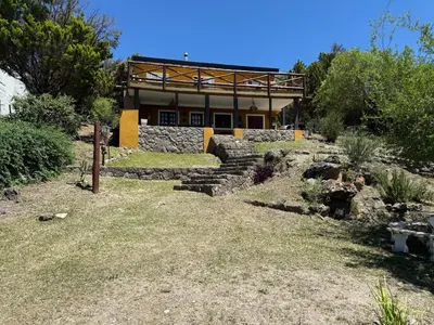 a building with stairs in front of a yard at Buena Vista Icho Cruz in Villa Icho Cruz