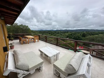 a patio with couches and tables on a balcony at Buena Vista Icho Cruz in Villa Icho Cruz