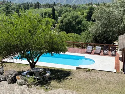 a swimming pool in a yard with a tree at Buena Vista Icho Cruz in Villa Icho Cruz