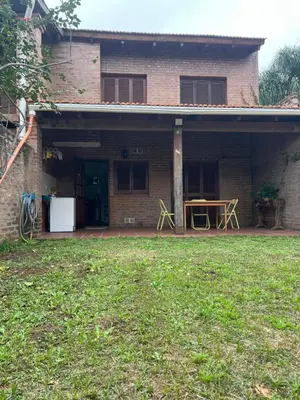 a brick house with a patio and a table at Duplex del Cerro in Cordoba
