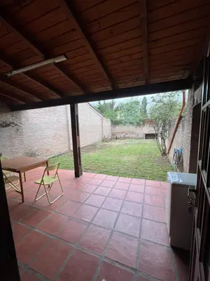 a patio with a table and a bench on it at Duplex del Cerro in Cordoba