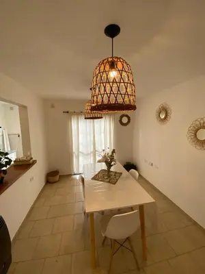 a dining room with a table and a chandelier at Complejo Arenas in Alta Gracia
