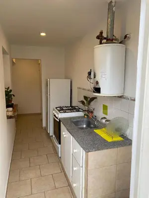 a kitchen with a sink and a refrigerator at Complejo Arenas in Alta Gracia