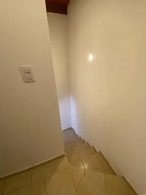 a room with a wall and a tile floor at Complejo Arenas in Alta Gracia