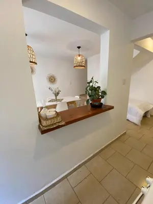 a dining room with a mirror on the wall at Complejo Arenas in Alta Gracia