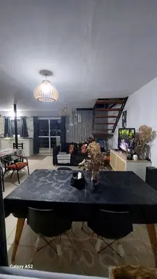 a living room with a dining room table with chairs at La Loma del Valle in Tanti