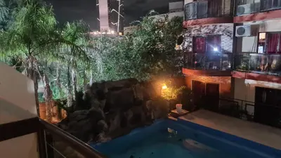a view of a swimming pool at night at Escaparte nunca se sintió tan bien, este es tu rincón para disfrutar in Villa Carlos Paz