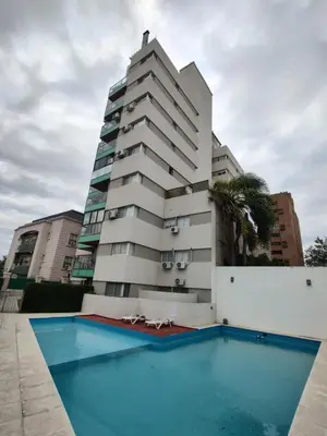 a building with a swimming pool in front of a building at Departamento Alta Cordoba Lautaro II Dormitorios con Pileta in Cordoba