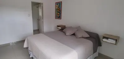 a bedroom with a white bed with pillows on it at Departamento Alta Cordoba Lautaro II Dormitorios con Pileta in Cordoba