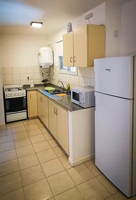 a kitchen with a white refrigerator and a microwave at Departamento SANATORIO ALLENDE - OULTON - GÜEMES - CENTRO - 5 MIN HOSPITAL PRIVADO - QUALITY - CÓRDOBA in Cordoba