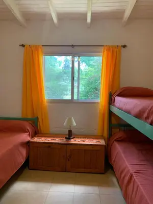 a bedroom with two bunk beds and a window at Espejo Escondido in Tanti