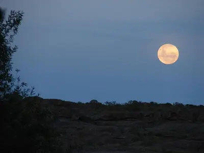 a full moon in the sky over a field at Espejo Escondido in Tanti
