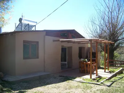 a small house with a wooden pergola at Espejo Escondido in Tanti