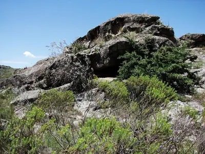 a rocky hill with plants on top of it at Espejo Escondido in Tanti