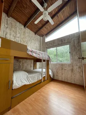 a bedroom with a bunk bed and a ceiling fan at Tila Huasi in Villa Icho Cruz