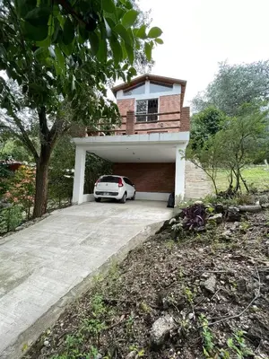 a white car parked in front of a house at Tila Huasi in Villa Icho Cruz