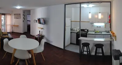 a small kitchen with a table and a white counter top at Depto. Lindo Excelente Ubicación in Cordoba
