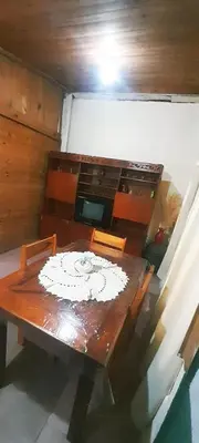 a dining room table with a white plate on it at Dpto en Santa María de Punilla in Cordoba