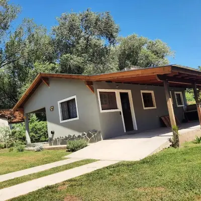 a house with a porch and a roof at Cabaña Kiara VGB in Villa General Belgrano