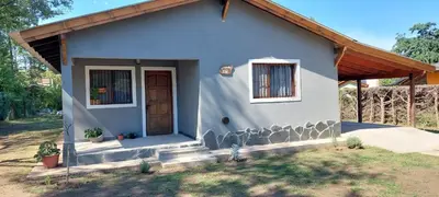a small blue house with a door and windows at Cabaña Kiara VGB in Villa General Belgrano