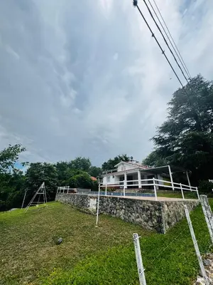 a house sitting on top of a stone wall at La Chuña in Villa Los Aromos