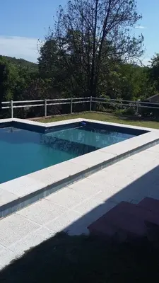 a large swimming pool with a fence around it at La Chuña in Villa Los Aromos